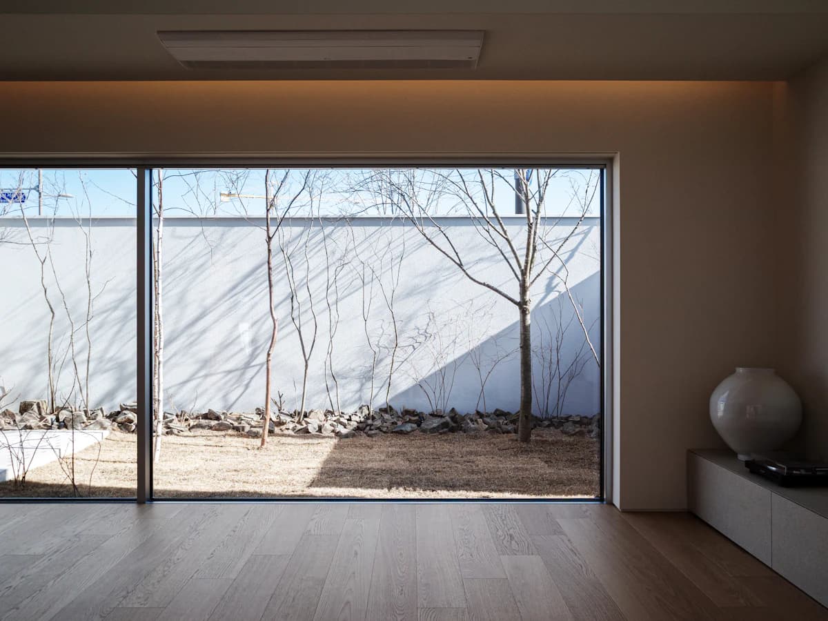 A minimal Korean clinic lounge with a courtyard view