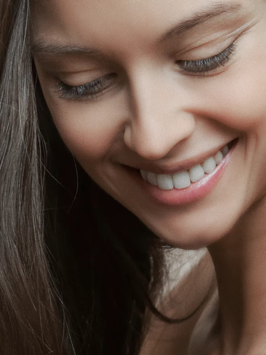 A woman with a straight, bright smile